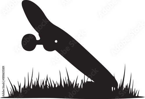 Black skateboard silhouette on grass white