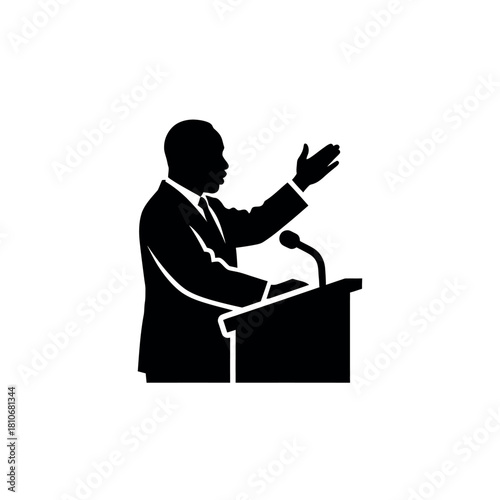 Silhouette of a speaker at a podium giving a speech.