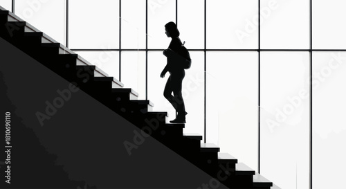 A black and white silhouette of a person with a backpack walking down a modern staircase against a brightly lit window.