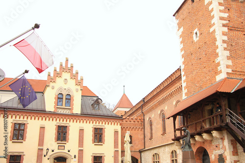 A Polish Flag and a EU Flag Hanging outside a Building in Kraków, Poland
