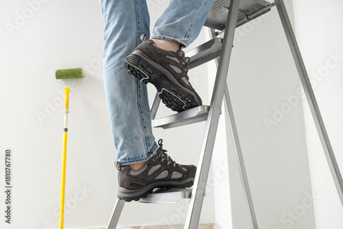 Young woman on stepladder d...