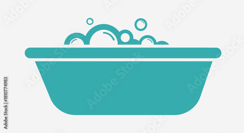 A turquoise bathtub filled with foamy bubbles, ready for a relaxing bath.