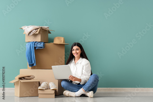 Young woman with laptop and...