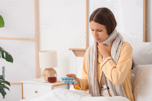 Ill young woman with throat...