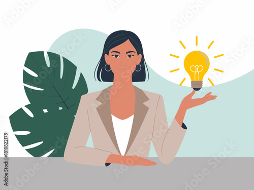 A confident woman stands behind a table holding a glowing lightbulb, representing innovation and creative ideas in a professional environment. A striking visual for inspiration.
