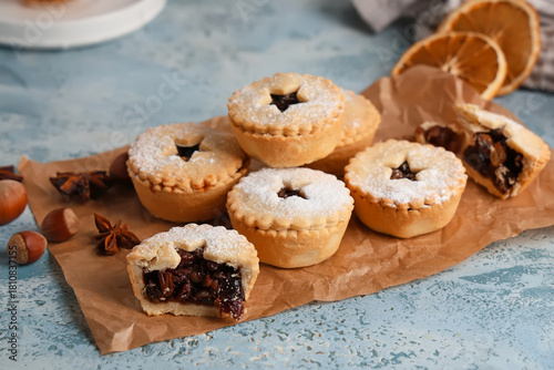 Konstfotografi Board with tasty Christmas mince pies and dried oranges on grunge blue backgroun