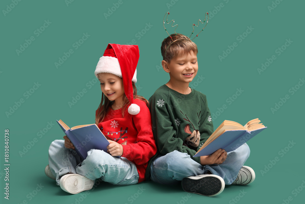 Naklejka premium Cute little children reading Christmas story on green background