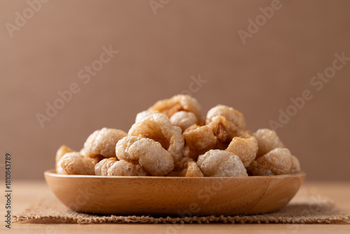 Konstfotografi Pork rind on a wooden plate, Northern Thai food