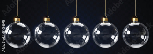 A row of five clear glass Christmas ornaments hang suspended against a dark blue patterned backdrop, creating a festive and elegant holiday scene. The ornaments are shiny.