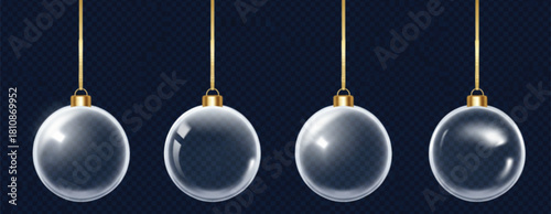 Four clear glass Christmas ornaments hang suspended by gold strings against a dark backdrop, creating a festive and elegant holiday atmosphere. 