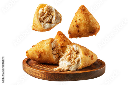 Crispy Brazil coxinha snack filled with shredded chicken croquettes and creamy cheese on wooden plate, isolated on white transparent background, concept of South American Cuisine