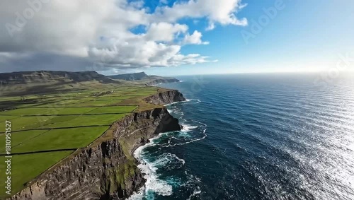 Dramatic coastal cliffs and green fields in northern ireland