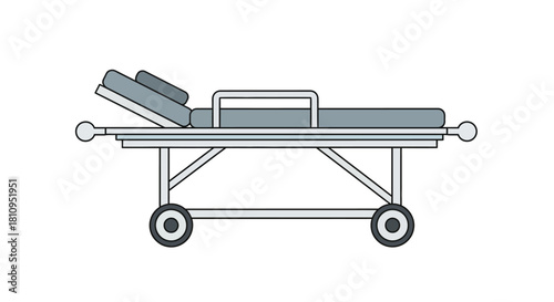 An elevated grey hospital stretcher with white frame tilted headrest and wheels