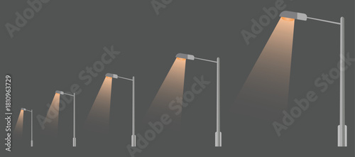 Row of streetlights illuminating the dark with a warm glow in the evening time.