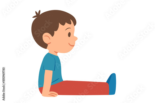 Cheerful young boy sitting on the floor with legs extended and smiling happily in profile view