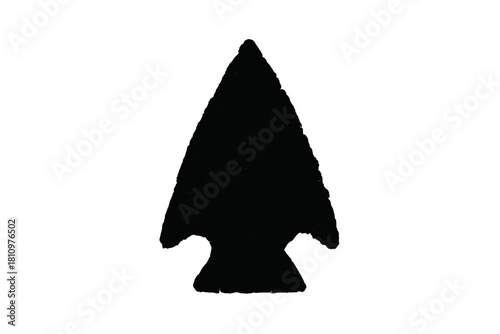 Black silhouette of ancient stone arrowhead with rough texture detail
