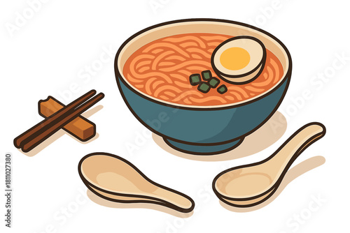 Classic Japanese ramen bowl with noodles, soft boiled egg, and chopped scallions served next to chopsticks and spoons