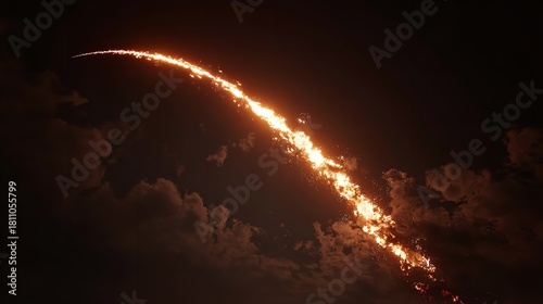 A fiery streak of light resembling a missile arcing in the sky