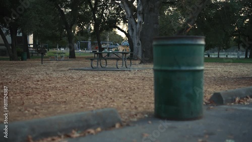 Wallpaper Mural Old green trash bin in quiet autumn city park foreground Torontodigital.ca