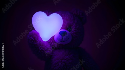 A cute teddy bear holding a bright heart for Valentine’s Day