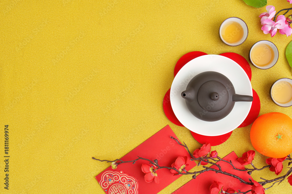 Naklejka premium Chinese New Year tea ceremony with traditional teapot and festive decorations