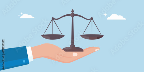 Hand holding scales of justice concept of fairness and balance in law