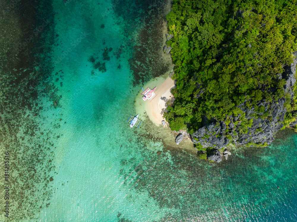 Fototapeta premium Boat over turquoise sea water in Bukal Island. El Nido, Palawan. Philippines.