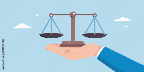 Hand holding scales of justice concept of fairness and equality