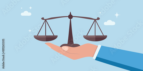 Hand holding scales of justice law fairness and balance concept