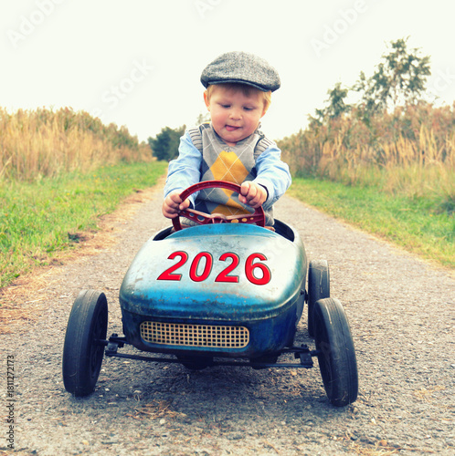 little boy driving a car in the new year 2026