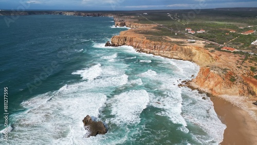 Rocky coastal cliff with natural arch in Faro, Algarve, Portugal