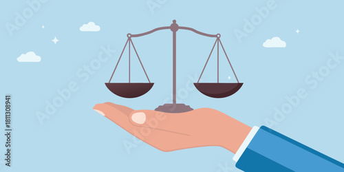 Hand holding scales of justice concept for law fairness and balance