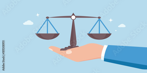Hand holding scales of justice concept of law and balance