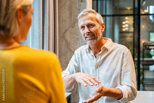 Mature colleagues having a business discussion in office setting