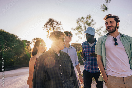 A diverse group of friends enjoy outdoor togetherness, celebrating unity, happiness, freedom, and youth in a vibrant summer lifestyle.