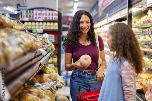 Latin mother and daughter doing grocery shopping together