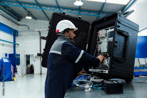 Engineer operating testing equipment in a workshop
