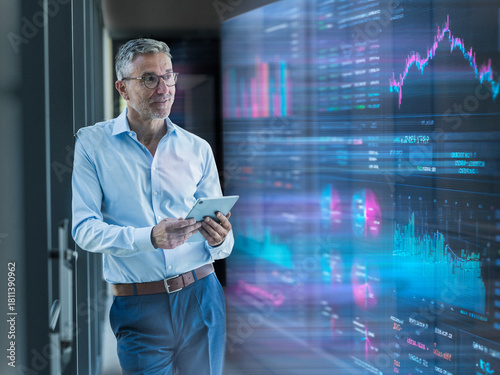 Engineer analyzing financial data on tablet in server room