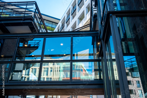 Modern architecture facade revealing structure, symmetry, geometry and reflection, strengthened by minimalism fused with strategic urban design and polished architectural detail