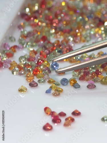 Colorful loose gemstone sparkling on white tray. Jewelry and gems business of selling