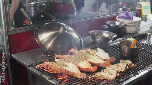  A street food vendor grills fresh spiny lobsters (langustas)