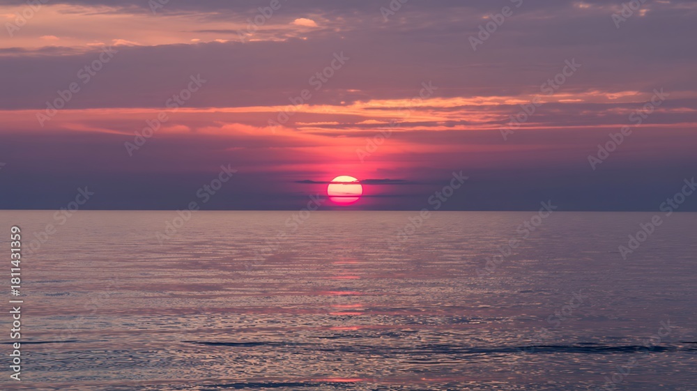 Fototapeta premium Serene Seascape at Sunset with Vibrant Magenta and Orange Sky