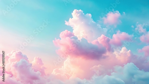 Soft pink clouds drift across a pale blue sky with a few wispy strands