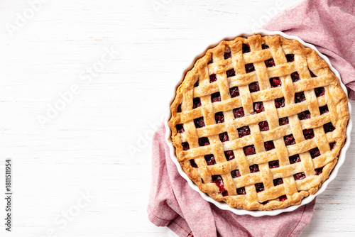 Εκτύπωση καμβά Classic American raspberry pie in ceramic pan on napkin on white wooden background