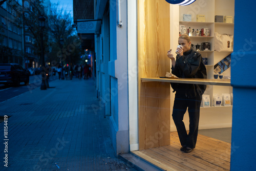 Woman drinking coffee in modern cafe