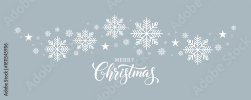 Vibrant Christmas vector banner featuring white "Merry Christmas" script calligraphy centered below a decorative curving border of large white snowflakes and stars, all set on a blue background.