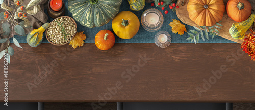 Fototapeta Naklejka Na Ścianę i Meble -  Thanksgiving table setting overhead banner with pumpkins, berries, glass candles, seeds bowl, cutting board, and empty space for text on wooden surface. 3D Rendering.