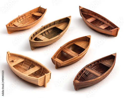 Collection of handcrafted wooden rowboats in various shades on white background