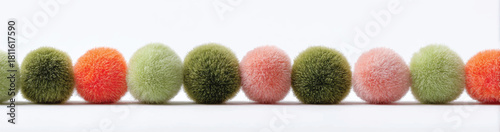 Colorful decorative pom poms line up in an eye catching arrangement