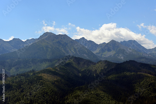 Fototapeta Naklejka Na Ścianę i Meble -  High Tatras seen from a metal observation tower with a modern glass terrace offering a stunning panorama at Poronin, Poland. Majestic mountains peaks of High Tatra moutnains.